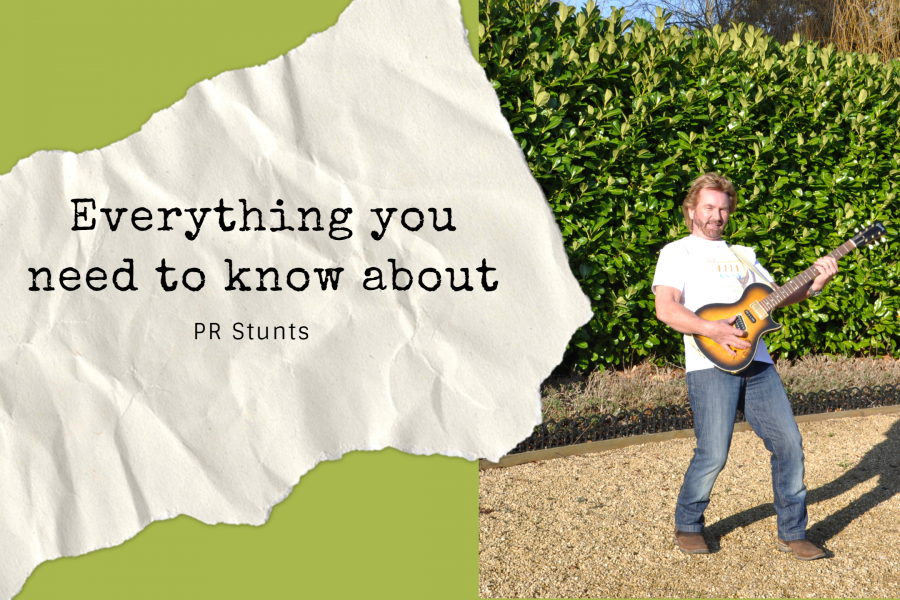 TV star Noel Edmonds holding a guitar and pretending to play in aid of a PR stunt by Palamedes for Samaritans